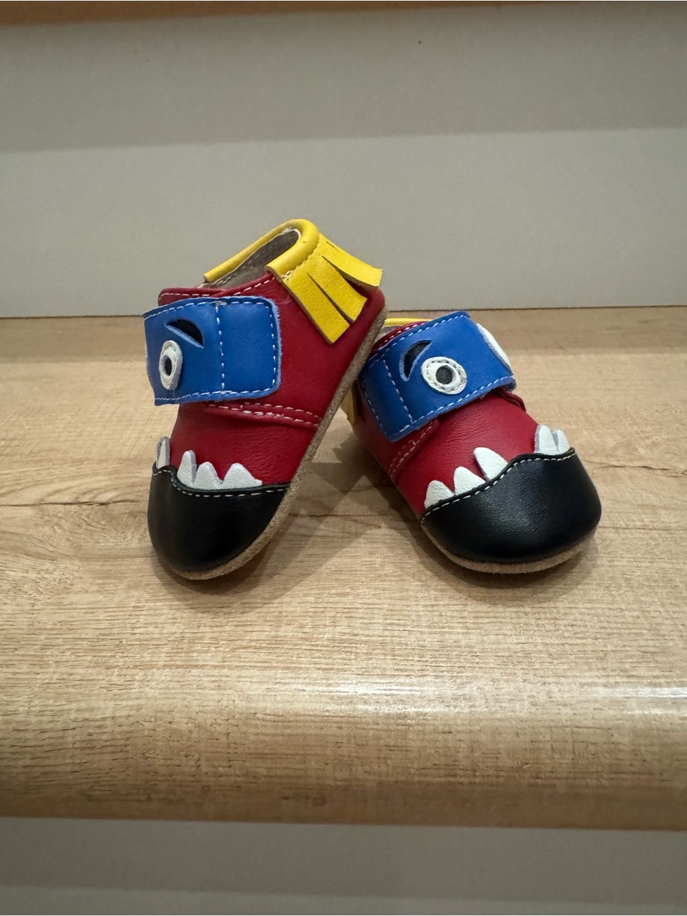 Livie & Luca Red Monster Moccasin Shoes with Blue & Yellow Accents